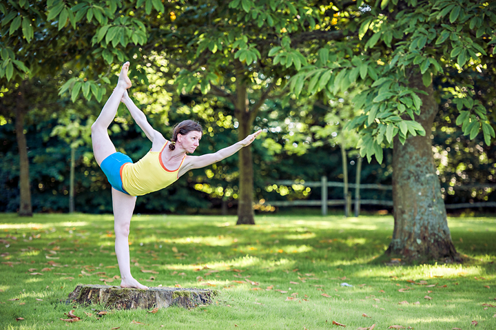 Woman performing standing bow pose yoga in forest - Stock Photo -  Masterfile - Premium Royalty-Free, Code: 6109-08830607